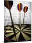 Darts on a Dartboard with Stock Figures in the Background-null-Mounted Premium Photographic Print