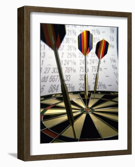 Darts on a Dartboard with Stock Figures in the Background-null-Framed Photographic Print