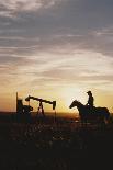 Old West, New West, Man Sitting on Horse with Oil Refinery at Sunset-David R^ Frazier-Photographic Print
