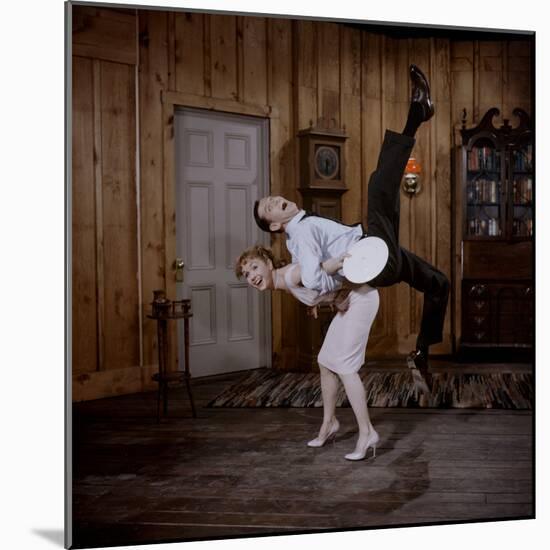 Debbie Reynolds Lifts Fellow Actor Tony Randall in a Scene from 'The Mating Game', 1959-Allan Grant-Mounted Photographic Print