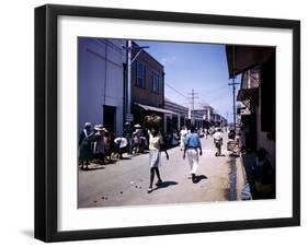 December 1946: Passersby at Market Street in Montego Bay, Jamaica-Eliot Elisofon-Framed Photographic Print