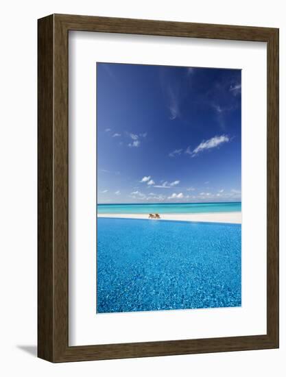 Deck chairs and infinity pool over amazing tropical lagoon, The Maldives, Indian Ocean, Asia-Sakis Papadopoulos-Framed Photographic Print