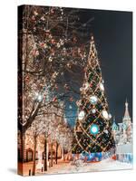 Decorations for New Year and Holidays. Christmas Balls on Tree Branches near to St. Basil's Cathedr-Mikhail St-Stretched Canvas