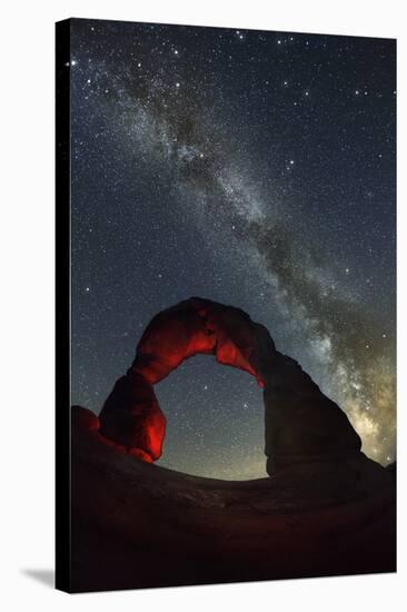 Delicate Arch and the Milky Way.-Jon Hicks-Stretched Canvas