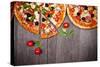 Delicious Italian Pizzas Served on Wooden Table-Jag_cz-Stretched Canvas