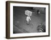 Delivery Boy Riding Bicycle with Box on Head-null-Framed Photographic Print