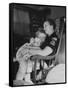Den Mother Still in Uniform, Sleeping While Holding Her Daughter-null-Framed Stretched Canvas