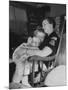 Den Mother Still in Uniform, Sleeping While Holding Her Daughter-null-Mounted Photographic Print