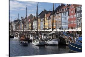 Denmark, Copenhagen, Nyhavn district. Colorful 17th and 18th century buildings, boats and canal-Alan Klehr-Stretched Canvas