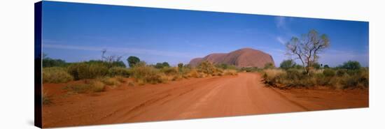 Desert Road and Ayers Rock, Australia-null-Stretched Canvas