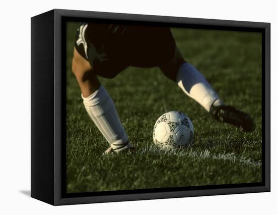 Detail of Foot About to Kick a Soccer Ball-Paul Sutton-Framed Stretched Canvas