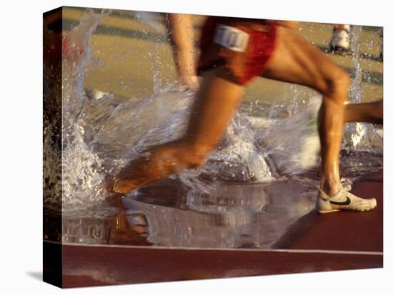 Detail of Runners Feet in Water Jump of Steeplechase Race-null-Stretched Canvas