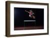 Determined Young Woman Athlete Jumping over a Hurdles-dotshock-Framed Photographic Print