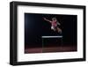 Determined Young Woman Athlete Jumping over a Hurdles-dotshock-Framed Photographic Print