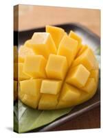 Diced Mango Still Attached to the Skin on Brown Plate-null-Stretched Canvas