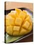 Diced Mango Still Attached to the Skin on Brown Plate-null-Stretched Canvas