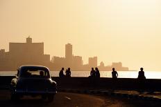 Skyline in La Habana, Cuba, at Sunset, with Vintage Cars on the Street and People Sitting on the Ma-Diego Cervo-Photographic Print