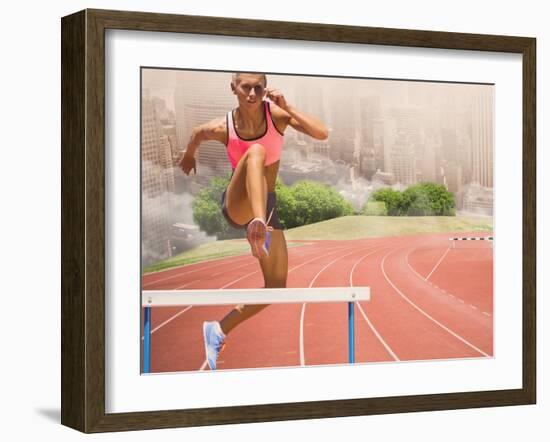 Digital Composite Image of Female Athlete Jumping above the Hurdle against Cityscape Background-vectorfusionart-Framed Photographic Print