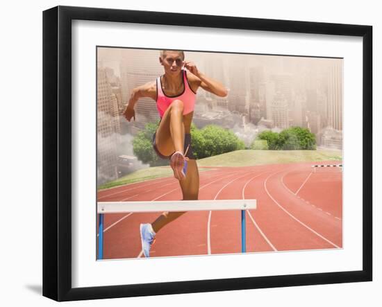 Digital Composite Image of Female Athlete Jumping above the Hurdle against Cityscape Background-vectorfusionart-Framed Photographic Print