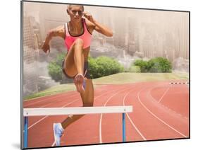 Digital Composite Image of Female Athlete Jumping above the Hurdle against Cityscape Background-vectorfusionart-Mounted Photographic Print