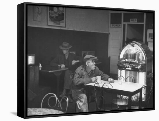 Dilapidated Shabby Man Sitting at the Table with a Cup of Coffee, Listening Dreamily to the Music-Peter Stackpole-Framed Stretched Canvas