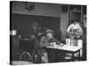 Dilapidated Shabby Man Sitting at the Table with a Cup of Coffee, Listening Dreamily to the Music-Peter Stackpole-Stretched Canvas