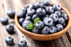 Ripe Blueberry in a Wooden Plate-dionisvera-Photographic Print