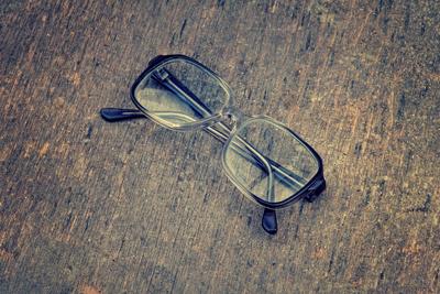Eyeglasses Laying on a Grungy Wooden Background with Retro Filter Effect