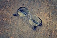 Eyeglasses Laying on a Grungy Wooden Background with Retro Filter Effect-Diplomedia-Framed Stretched Canvas