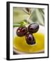 Dipping Olive Sprig with Black Olives in Olive Oil-null-Framed Photographic Print