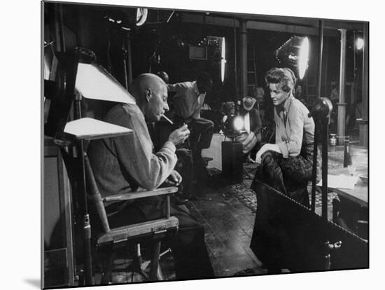 Director Howard Hawks Conferring with Actress Angie Dickinson on Set for "Rio Bravo"-Allan Grant-Mounted Premium Photographic Print