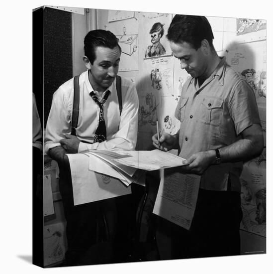 Director Walt Disney Looking over Sketches from His Latest Picture "Pinocchio."-Peter Stackpole-Stretched Canvas