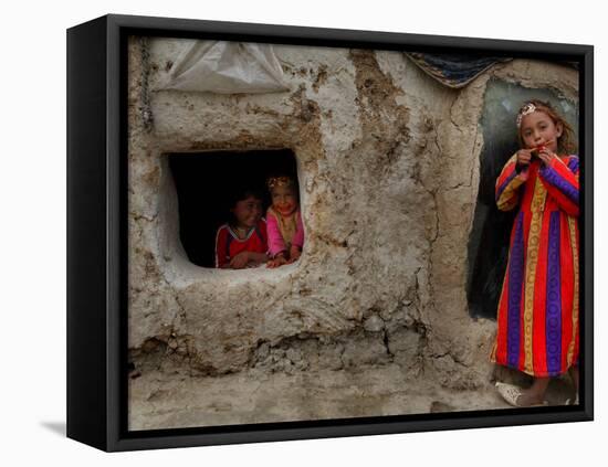 Displaced Girls Smile as They Look Out from a Shanty, in a Refugee Camp in Kabul, Afghanistan-null-Framed Stretched Canvas