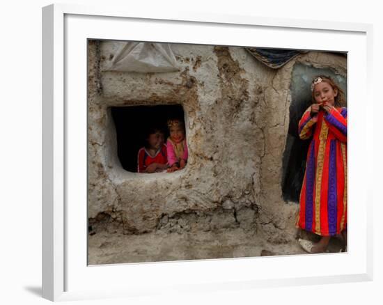 Displaced Girls Smile as They Look Out from a Shanty, in a Refugee Camp in Kabul, Afghanistan-null-Framed Photographic Print