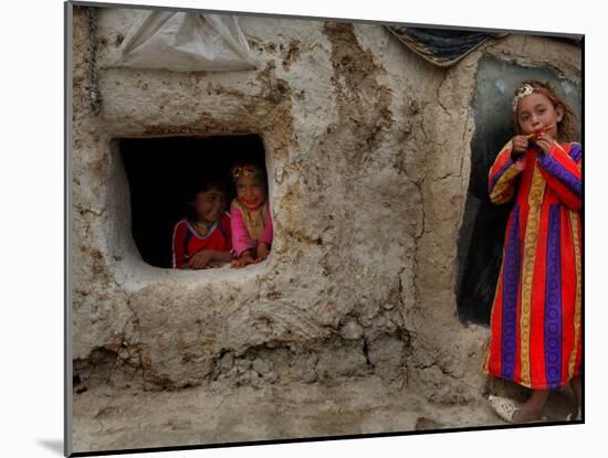 Displaced Girls Smile as They Look Out from a Shanty, in a Refugee Camp in Kabul, Afghanistan-null-Mounted Photographic Print