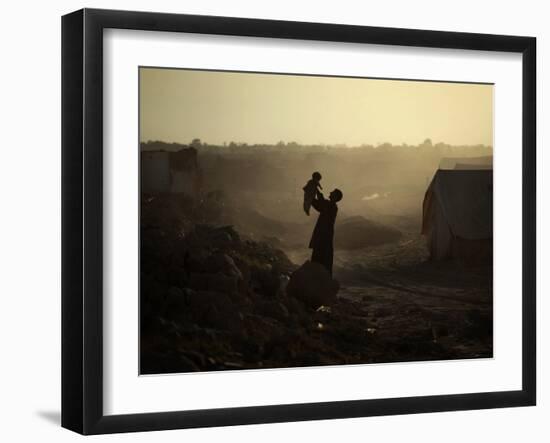 Displaced Man Holds His Baby Next to His Tent in Jalozai Refugee Camp Near Peshawar, Pakistan-null-Framed Photographic Print