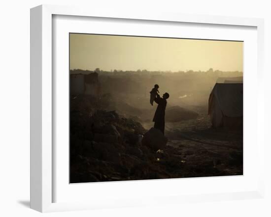 Displaced Man Holds His Baby Next to His Tent in Jalozai Refugee Camp Near Peshawar, Pakistan-null-Framed Photographic Print