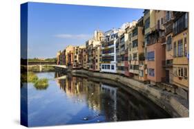 Distinctive historic colourful arcaded houses and Onyar River, Girona, Girona Province, Catalonia, -Eleanor Scriven-Stretched Canvas