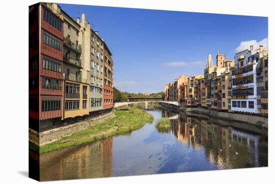 Distinctive historic colourful arcaded houses and Onyar River, Girona, Girona Province, Catalonia, -Eleanor Scriven-Stretched Canvas