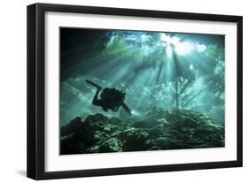 Diver Passes Through Light Beams in Chac Mool Cenote in Mexico-null-Framed Photographic Print