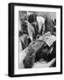 Doctor Attends to Injured Man-null-Framed Photographic Print