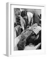 Doctor Attends to Injured Man-null-Framed Photographic Print