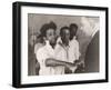 Doctor examining inmate's hand-Lucien Aigner-Framed Photographic Print