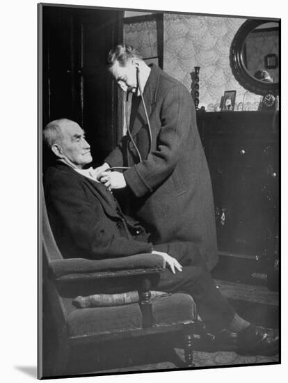 Doctor Making a House Call to an Ill Elderly Man, Listening to the Rhythm of His Heart-null-Mounted Photographic Print