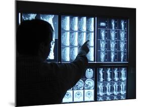 Doctor Pointing to X-Ray Images on Computer Screen-null-Mounted Photographic Print