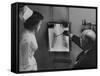 Doctors Examining X-Ray with Nurse-null-Framed Stretched Canvas