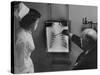 Doctors Examining X-Ray with Nurse-null-Stretched Canvas