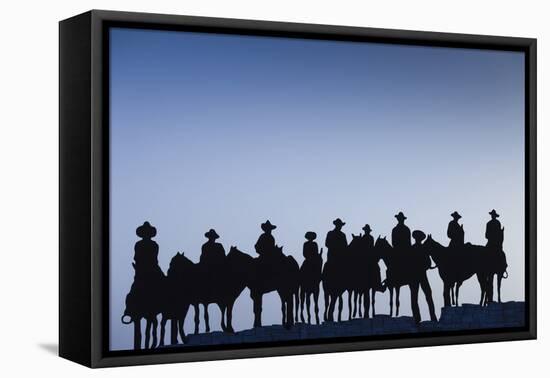 Dodge City Sign with Cowboy Silhouettes, Kansas, USA-Walter Bibikow-Framed Stretched Canvas