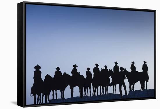 Dodge City Sign with Cowboy Silhouettes, Kansas, USA-Walter Bibikow-Framed Stretched Canvas