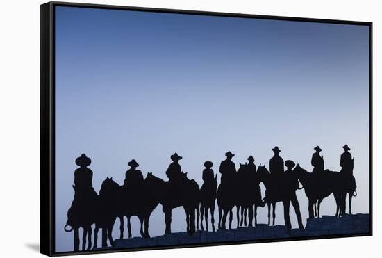 Dodge City Sign with Cowboy Silhouettes, Kansas, USA-Walter Bibikow-Framed Stretched Canvas